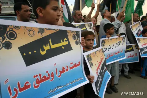Palestinian protesters holds a sign during a demonstration against president mahmoud abbas after his press statements about refugees and the right of return, in Khan Younis in southern Gaza Strip, on November 03, 2012. P...