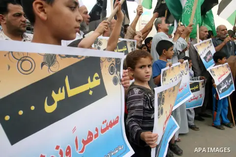 Palestinian protesters holds a sign during a demonstration against president mahmoud abbas after his press statements about refugees and the right of return, in Khan Younis in southern Gaza Strip, on November 03, 2012. P...