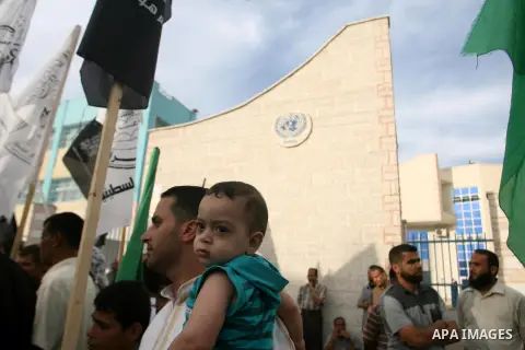 Palestinian protesters holds a sign during a demonstration against president mahmoud abbas after his press statements about refugees and the right of return, in Khan Younis in southern Gaza Strip, on November 03, 2012. P...