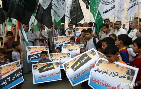 Palestinian protesters holds a sign during a demonstration against president mahmoud abbas after his press statements about refugees and the right of return, in Khan Younis in southern Gaza Strip, on November 03, 2012. P...
