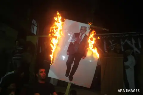 A Hamas supporter burns a poster depicting Palestinian President Mahmoud Abbas during a protest in Jabalya in the northern Gaza Strip November 3, 2012. Abbas made a rare if symbolic concession to Israel on Thursday, sayi...