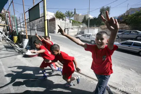 Palestinian children participate in the marathon of " Run for Silwan" in Jerusalem on 4 November 2012. The run for Silwan marathon highlights checkpoint system from Bethlehem to Wadi Hilweh, participants follow a route s...