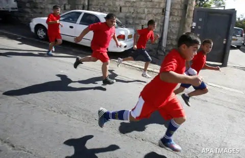 Palestinian children participate in the marathon of " Run for Silwan" in Jerusalem on 4 November 2012. The run for Silwan marathon highlights checkpoint system from Bethlehem to Wadi Hilweh, participants follow a route s...