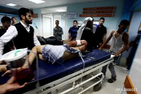 A wounded Palestinian is wheeled on a stretcher at a hospital in Gaza City following Israeli shelling November 10, 2012. Israeli tank shells killed at least two Palestinians and wounded 20 in the Gaza Strip on Saturday a...