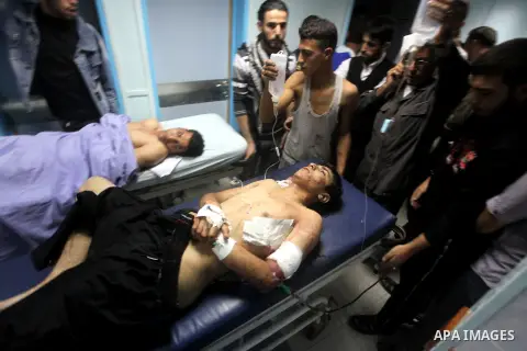 A wounded Palestinian is wheeled on a stretcher at a hospital in Gaza City following Israeli shelling November 10, 2012. Israeli tank shells killed at least two Palestinians and wounded 20 in the Gaza Strip on Saturday a...