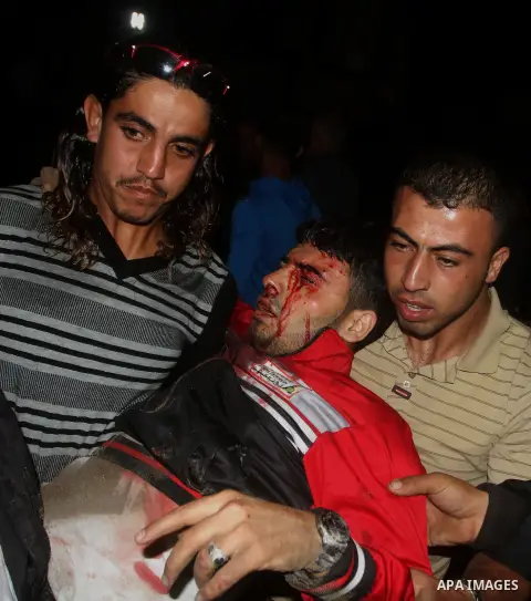 Palestinians carry a wounded man into a hospital in Gaza City following Israeli shelling November 10, 2012. Israeli tank shells killed at least Four Palestinians and wounded 20 in the Gaza Strip on Saturday after an appa...