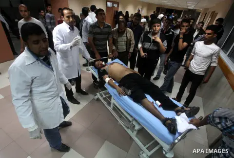 A wounded Palestinian is wheeled on a stretcher at a hospital in Gaza City following Israeli shelling November 10, 2012. Israeli tank shells killed at least two Palestinians and wounded 20 in the Gaza Strip on Saturday a...