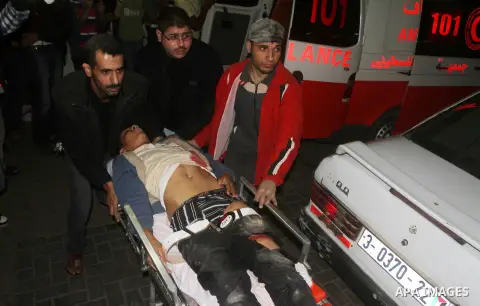 A wounded Palestinian is wheeled on a stretcher at a hospital in Gaza City following Israeli shelling November 10, 2012. Israeli tank shells killed at least two Palestinians and wounded 20 in the Gaza Strip on Saturday a...