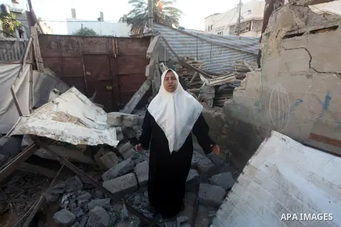 Palestinians inspect damage in their house damaged in an Israeli air strike in Gaza City November 11, 2012. An Israeli air strike killed a Palestinian militant in the Hamas-governed Gaza Strip on Sunday as a surge in cro...