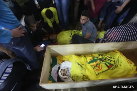 Mourners carry the body of Palestinian Matar Abu Ata, 20, killed in a recent Israeli strike, during his funeral in Gaza City, Sunday, Nov. 11, 2012. While cross-border fighting is a common occurrence, hostilities spirale...