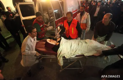 Palestinians wheel a wounded woman into the treatment room of al-Shifa hospital following an Israeli airstrike in Gaza City, Wednesday, Nov. 14, 2012. The Israeli military said its assassination of the Hamas military com...