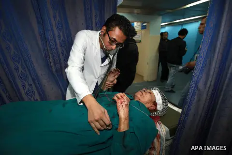 A Palestinian medic treats a wounded woman into the treatment room of Shifa hospital following an Israeli airstrike in Gaza City, Wednesday, Nov. 14, 2012. The Israeli military said its assassination of the Hamas militar...