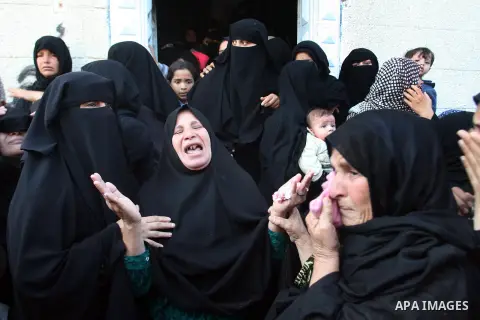 Palestinian relatives of Hisham Ghalban mourn during his funeral in Khan Younis in the southern Gaza Strip, on November 15, 2012. Tensions between Israel and Gaza have sparked a furious response from Egypt's Islamist adm...