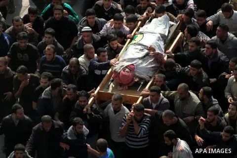 Palestinian mourners carry the body of Ahmad Jaabari, head of the military wing of the Hamas movement, the Ezzedin Qassam Brigades, during his funeral in Gaza City, on November 15, 2012. Tensions between Israel and Gaza...