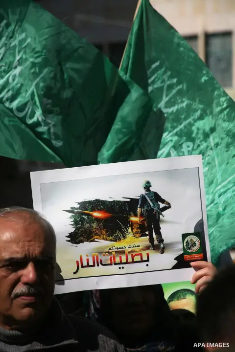 Palestinian Hamas supporters march during a demonstration in support of the people of the Gaza Strip and against Israeli air strikes in the West Bank city of Hebron on November 15, 2012 . Several Palestinians were killed...