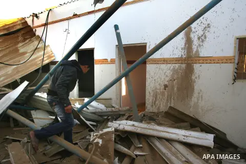 A Palestinian man inspects the damage in his house hit by a missile fired by Israeli air forces in the southern of Gaza strip town of Rafah, November 15, 2012. Several Palestinians were killed following a series of Israe...