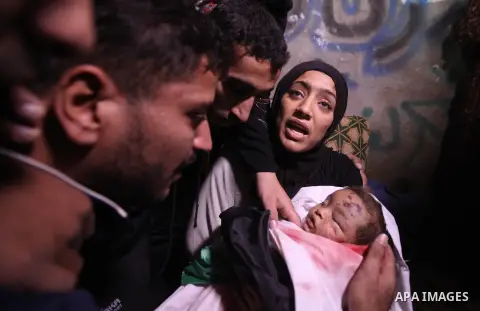 The mother of 10-month-old Palestinian girl, Hanen Tafesh, killed the day before in an Israeli air strike, mourns over her body before her funeral in Gaza City, on November 16, 2012. Israeli warplanes carried out multipl...
