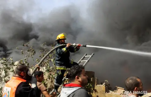 Firefighters try to extinguish a fire in a factory which according to Palestinians was hit by an Israeli air strike in Gaza November 16, 2012. Egyptian Prime Minister Hisham Kandil arrived in the Gaza Strip on Friday to...