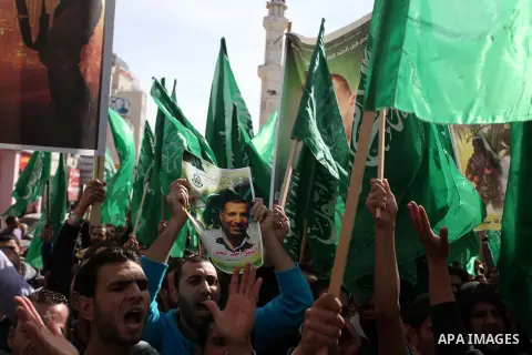Palestinian Hamas supporters wave flags during a protest against Israel's operations in Gaza Strip, in the West Bank city of Ramallah 16 November 2012. Reports state that missiles continue to be fired on Israeli targets...