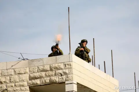 Israel soldiers fire tear gas at Palestinian demonstrators during clashes following a protest against Israel's operations in Gaza Strip in the village of Beit Ummar near the West Bank city of Hebron on November, 16, 2012...