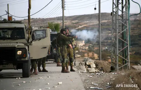Israel soldiers fire tear gas at Palestinian demonstrators during clashes following a protest against Israel's operations in Gaza Strip in the village of Beit Ummar near the West Bank city of Hebron on November, 16, 2012...