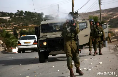 Israel soldiers fire tear gas at Palestinian demonstrators during clashes following a protest against Israel's operations in Gaza Strip in the village of Beit Ummar near the West Bank city of Hebron on November, 16, 2012...