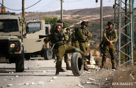 Israel soldiers fire tear gas at Palestinian demonstrators during clashes following a protest against Israel's operations in Gaza Strip in the village of Beit Ummar near the West Bank city of Hebron on November, 16, 2012...