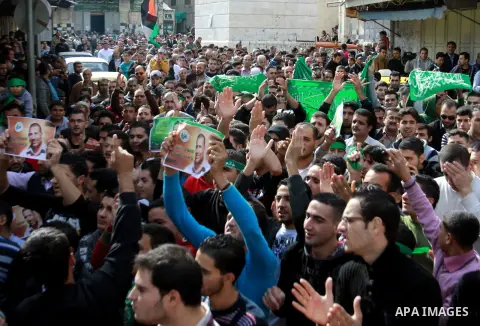 Palestinian Hamas supporters wave flags during a protest against Israel's operations in Gaza Strip, in the West Bank city of Nablus 16 November 2012. Reports state that missiles continue to be fired on Israeli targets by...