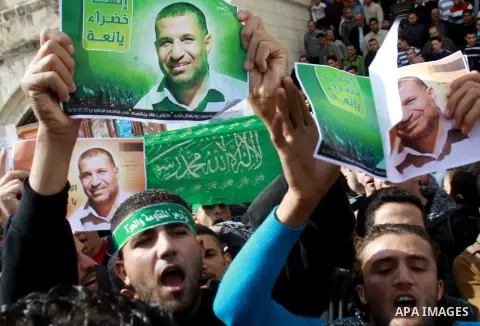 Palestinian Hamas supporters wave flags during a protest against Israel's operations in Gaza Strip, in the West Bank city of Nablus 16 November 2012. Reports state that missiles continue to be fired on Israeli targets by...