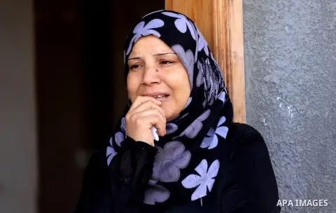 Palestinian women of Audi Naser 10 years, cries during his funeral after he was killed in an Israeli air strike, during his funeral in Beit Hanun, northern Gaza Strip on 16 November 2012. Missiles continue to be fired on...