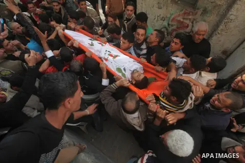 Palestinian mourners carry the bodies of Tahrer Salman and Mohammed Salman in Beit Lahia, north Gaza, Friday, Nov. 16, 2012. According to relatives, the two members of the Salman family were killed after an Israeli airst...