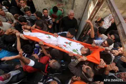 Palestinian mourners carry the bodies of Tahrer Salman and Mohammed Salman in Beit Lahia, north Gaza, Friday, Nov. 16, 2012. According to relatives, the two members of the Salman family were killed after an Israeli airst...