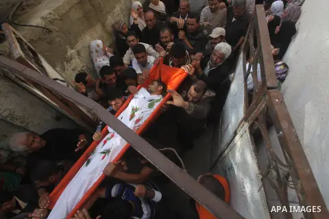 Palestinian mourners carry the bodies of Tahrer Salman and Mohammed Salman in Beit Lahia, north Gaza, Friday, Nov. 16, 2012. According to relatives, the two members of the Salman family were killed after an Israeli airst...