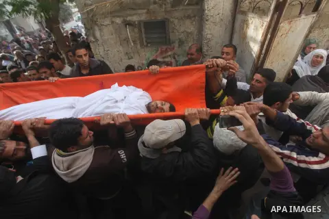 Palestinian mourners carry the bodies of Tahrer Salman and Mohammed Salman in Beit Lahia, north Gaza, Friday, Nov. 16, 2012. According to relatives, the two members of the Salman family were killed after an Israeli airst...