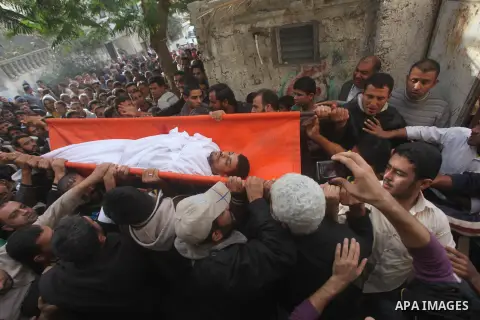 Palestinian mourners carry the bodies of Tahrer Salman and Mohammed Salman in Beit Lahia, north Gaza, Friday, Nov. 16, 2012. According to relatives, the two members of the Salman family were killed after an Israeli airst...