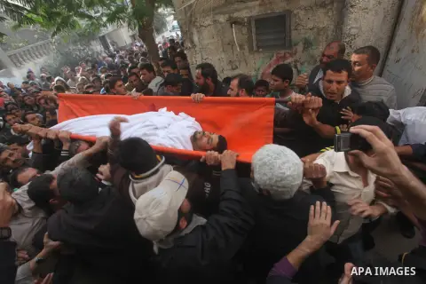 Palestinian mourners carry the bodies of Tahrer Salman and Mohammed Salman in Beit Lahia, north Gaza, Friday, Nov. 16, 2012. According to relatives, the two members of the Salman family were killed after an Israeli airst...