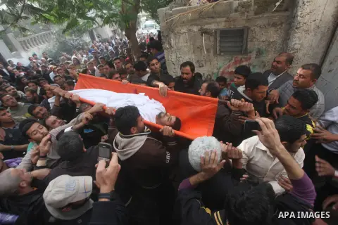 Palestinian mourners carry the bodies of Tahrer Salman and Mohammed Salman in Beit Lahia, north Gaza, Friday, Nov. 16, 2012. According to relatives, the two members of the Salman family were killed after an Israeli airst...