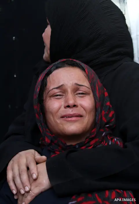 Palestinian women cry during the funeral of Tahrer Salman and Mohammed Salman in Beit Lahia, north Gaza, Friday, Nov. 16, 2012. According to relatives, the two members of the Salman family were killed after an Israeli ai...