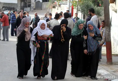 Palestinian women cry during the funeral of Tahrer Salman and Mohammed Salman in Beit Lahia, north Gaza, Friday, Nov. 16, 2012. According to relatives, the two members of the Salman family were killed after an Israeli ai...