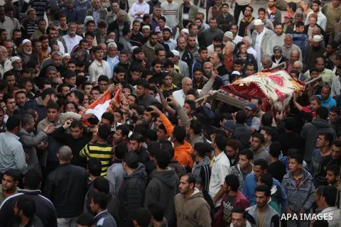 Palestinian mourners carry the bodies of Tahrer Salman and Mohammed Salman in Beit Lahia, north Gaza, Friday, Nov. 16, 2012. According to relatives, the two members of the Salman family were killed after an Israeli airst...