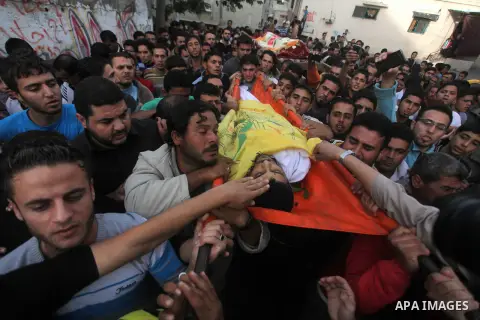 Palestinian mourners carry the bodies of Tahrer Salman and Mohammed Salman in Beit Lahia, north Gaza, Friday, Nov. 16, 2012. According to relatives, the two members of the Salman family were killed after an Israeli airst...
