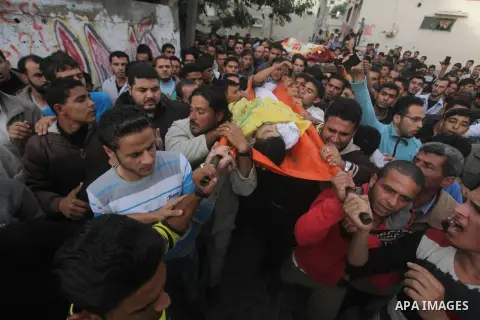 Palestinian mourners carry the bodies of Tahrer Salman and Mohammed Salman in Beit Lahia, north Gaza, Friday, Nov. 16, 2012. According to relatives, the two members of the Salman family were killed after an Israeli airst...