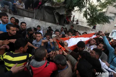 Palestinian mourners carry the bodies of Tahrer Salman and Mohammed Salman in Beit Lahia, north Gaza, Friday, Nov. 16, 2012. According to relatives, the two members of the Salman family were killed after an Israeli airst...