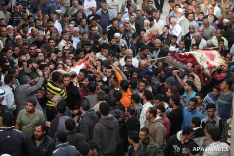 Palestinian mourners carry the bodies of Tahrer Salman and Mohammed Salman in Beit Lahia, north Gaza, Friday, Nov. 16, 2012. According to relatives, the two members of the Salman family were killed after an Israeli airst...