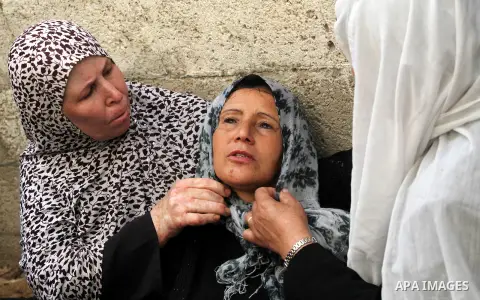 Palestinian women cry during the funeral of Tahrer Salman and Mohammed Salman in Beit Lahia, north Gaza, Friday, Nov. 16, 2012. According to relatives, the two members of the Salman family were killed after an Israeli ai...