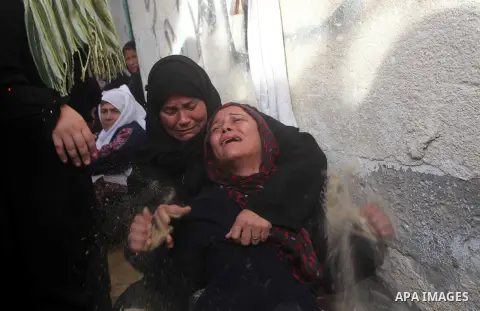 Palestinian women cry during the funeral of Tahrer Salman and Mohammed Salman in Beit Lahia, north Gaza, Friday, Nov. 16, 2012. According to relatives, the two members of the Salman family were killed after an Israeli ai...