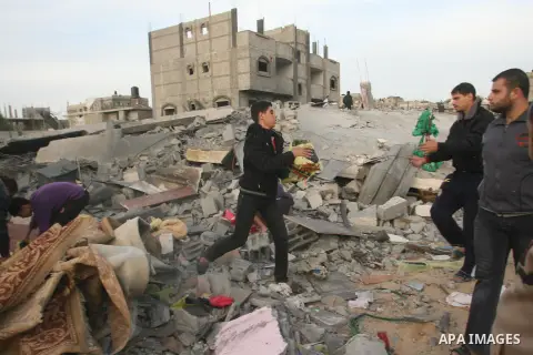 Palestinians inspect the rubble of the destroyed house of Hamas militant Mohammad Abu Shmala, following an Israeli air strike in Rafah, southern Gaza Strip, Friday, Nov. 16, 2012. Photo by Eyad Al Baba