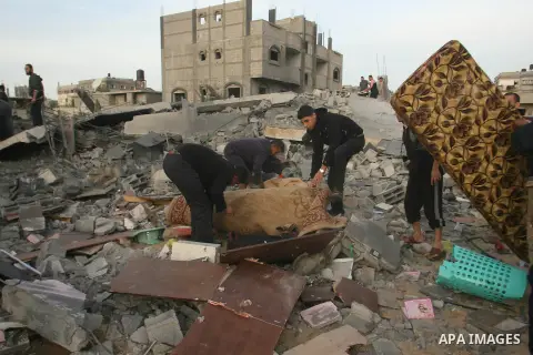 Palestinians inspect the rubble of the destroyed house of Hamas militant Mohammad Abu Shmala, following an Israeli air strike in Rafah, southern Gaza Strip, Friday, Nov. 16, 2012. Photo by Eyad Al Baba