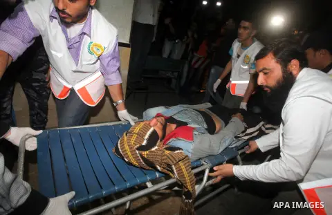 Palestinians carries an manchild into the treatment room of Shifa hospital following an Israeli airstrike, in Gaza City, Friday, Nov. 16, 2012. Fierce clashes between Israeli forces and Gaza militants are continuing for...