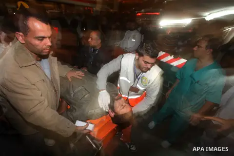 Palestinians carries an man into the treatment room of Shifa hospital following an Israeli airstrike, in Gaza City, Friday, Nov. 16, 2012. Fierce clashes between Israeli forces and Gaza militants are continuing for the t...